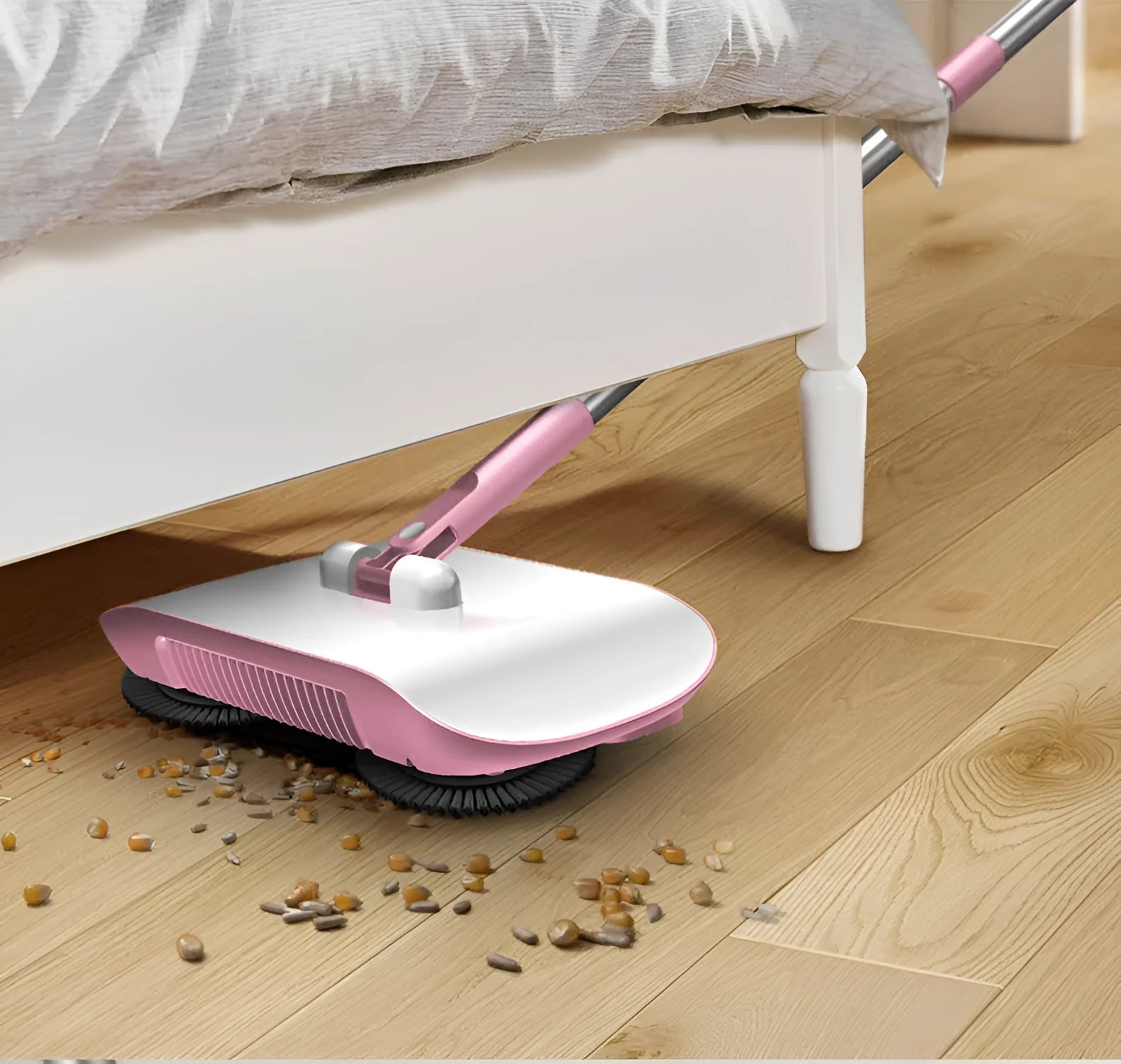 Pink hand push sweeper with rotating brush and mop attachment on tiled floor