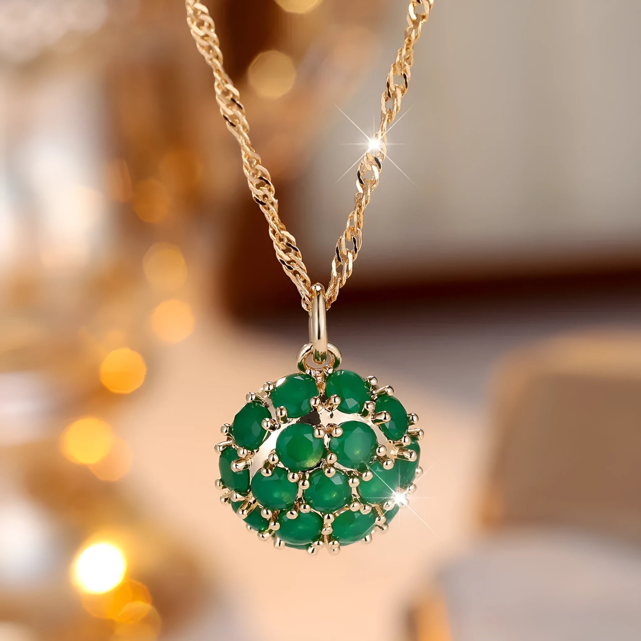 Round emerald pendant necklace with diamond surround on champagne gold chain