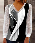 Purple loose V-neck top with lace print detail and long sleeves on a hanger.