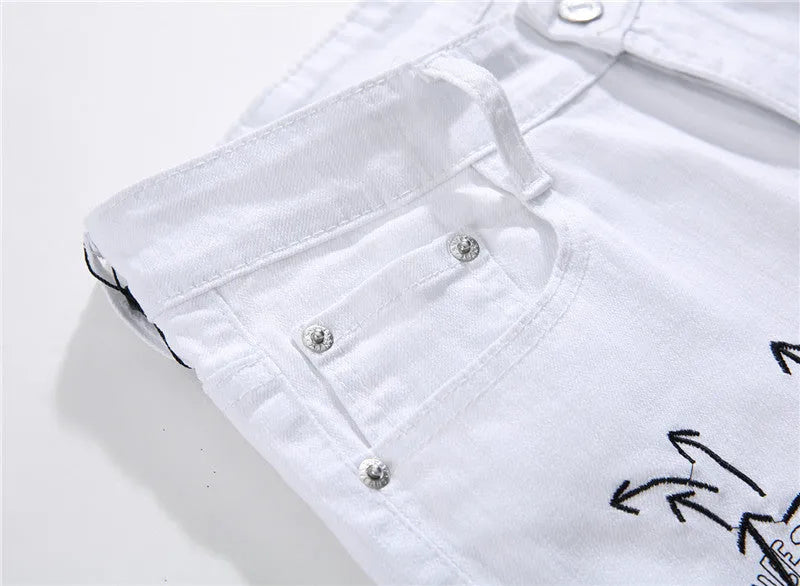 White shredded embroidery jeans in cotton denim, sizes 29-38, with ripped and embroidered details.
