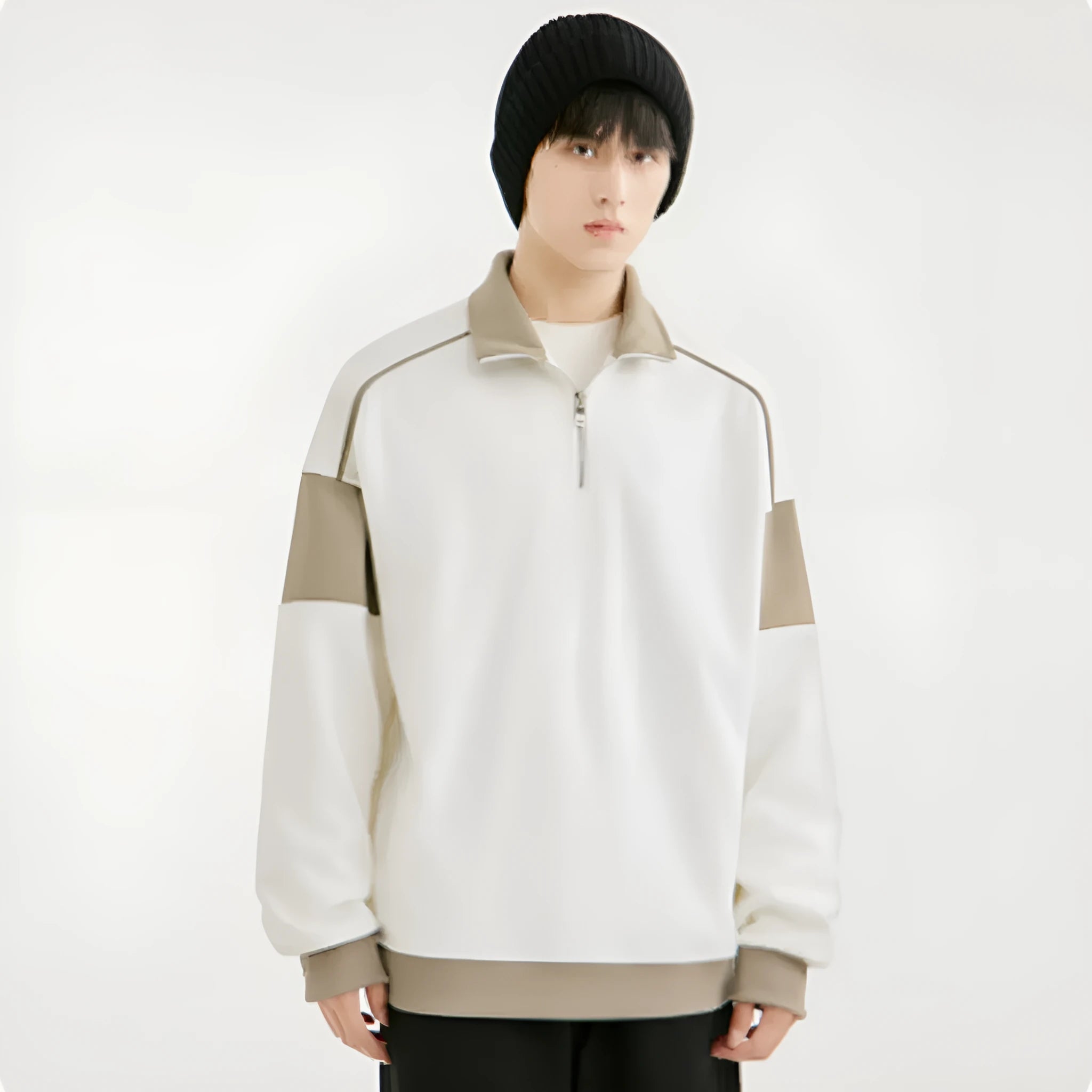 Man wearing a beige drop shoulder hooded corduroy pullover sweater with loose lapels
