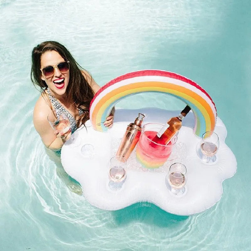 Rainbow inflatable pool float cooler with cloud shape and four glass holders floating on blue water