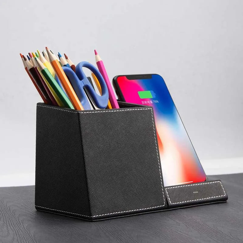 Black leather wireless charging station with phone on stand and pens in holder