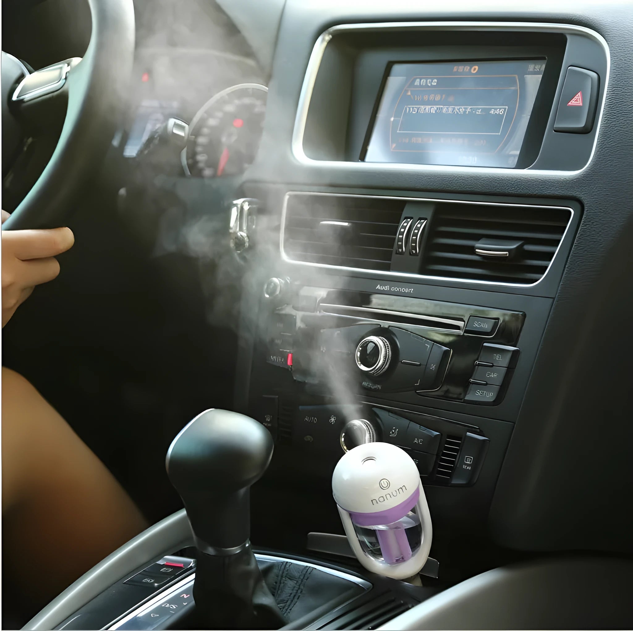Blue portable car humidifier with essential oil diffuser function on car dashboard