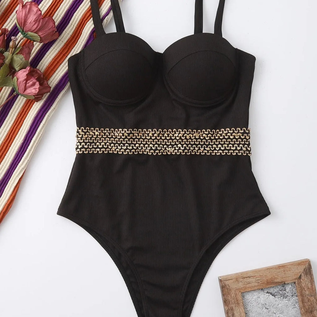 Black women's one-piece swimsuit with adjustable shoulder straps on hanger with hard storage bag