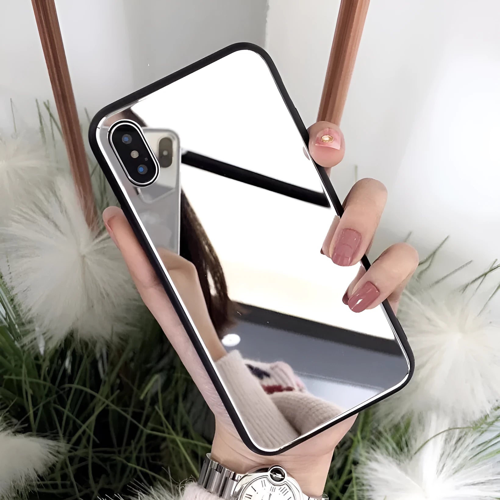 Black iPhone back cover case with a reflective mirror surface and self-timer function.