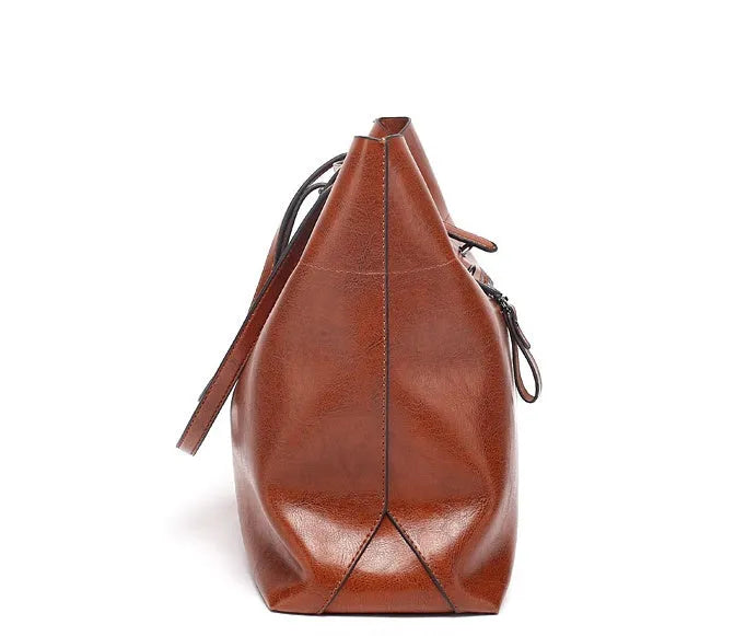 Horizontal wax cowhide leather handbag showing cross-body strap and internal organisation with phone pocket