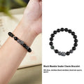 Men's black obsidian and sterling silver snake bracelet with retro design on a wrist.