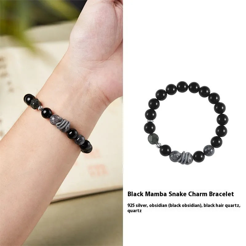 Men's black obsidian and sterling silver snake bracelet with retro design on a wrist.