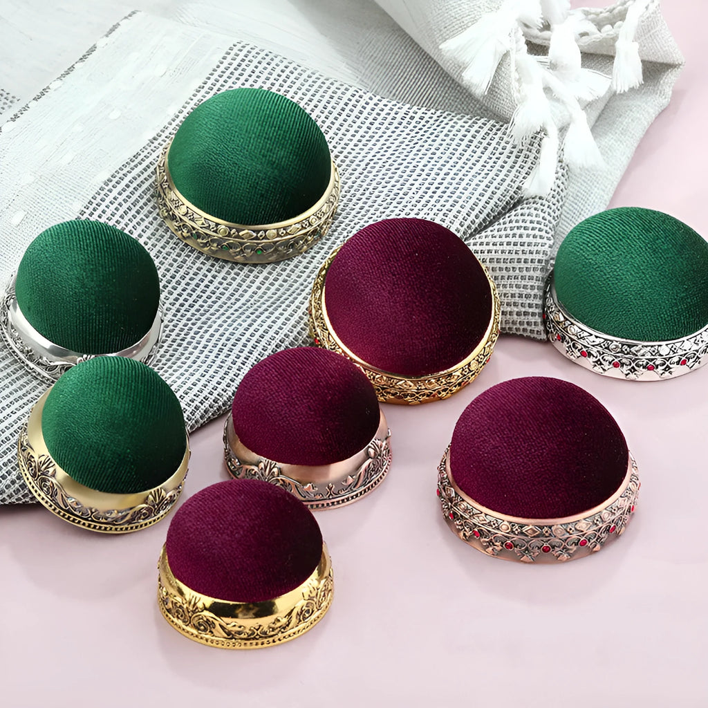 Retro needle ball head pin cushion with velvet cover and alloy insert on sewing table