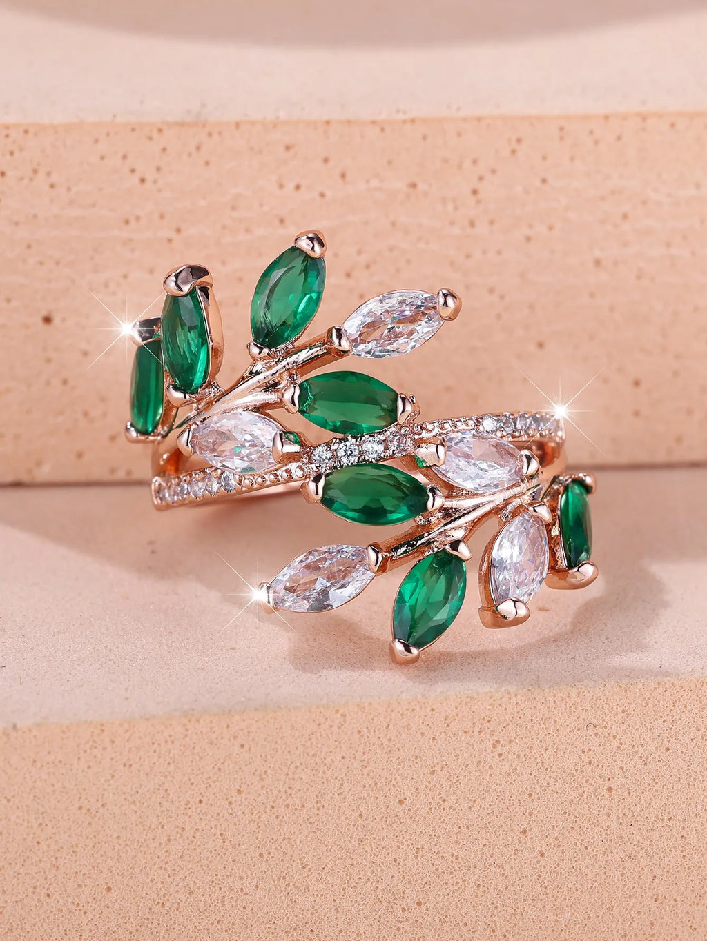 Adjustable leaf ring with horse eye zircon stone in rose gold finish on wooden background