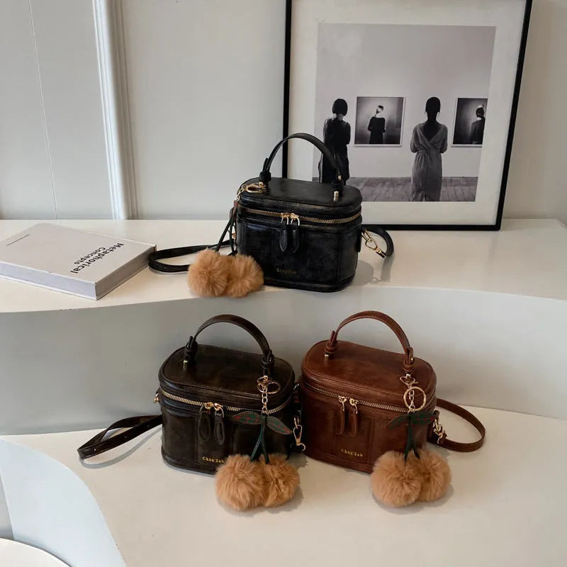 Box bucket bag in PU material with sewing line detail, available in Black, Brown, and Coffee, includes a free pendant