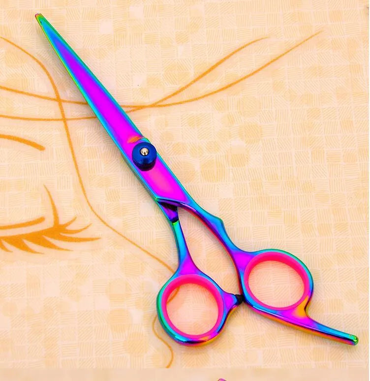 Three pet grooming scissors with purple handles on white background including curved flat and tooth shears