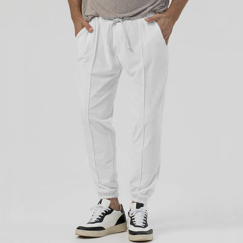 Men's grey elastic track sweatpants with tapered straight-leg design and elastic waistband