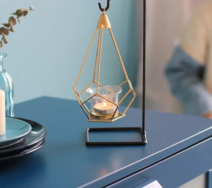 Set of six Nordic iron candle holders in various styles for block candles on a wooden shelf