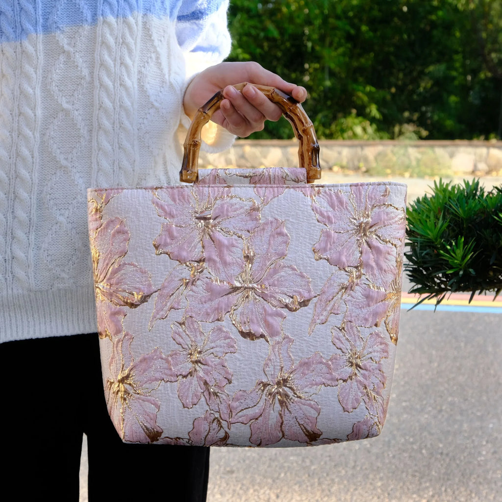 Light blue square canvas shoulder bag with bronzing flower detail and double strap connectors