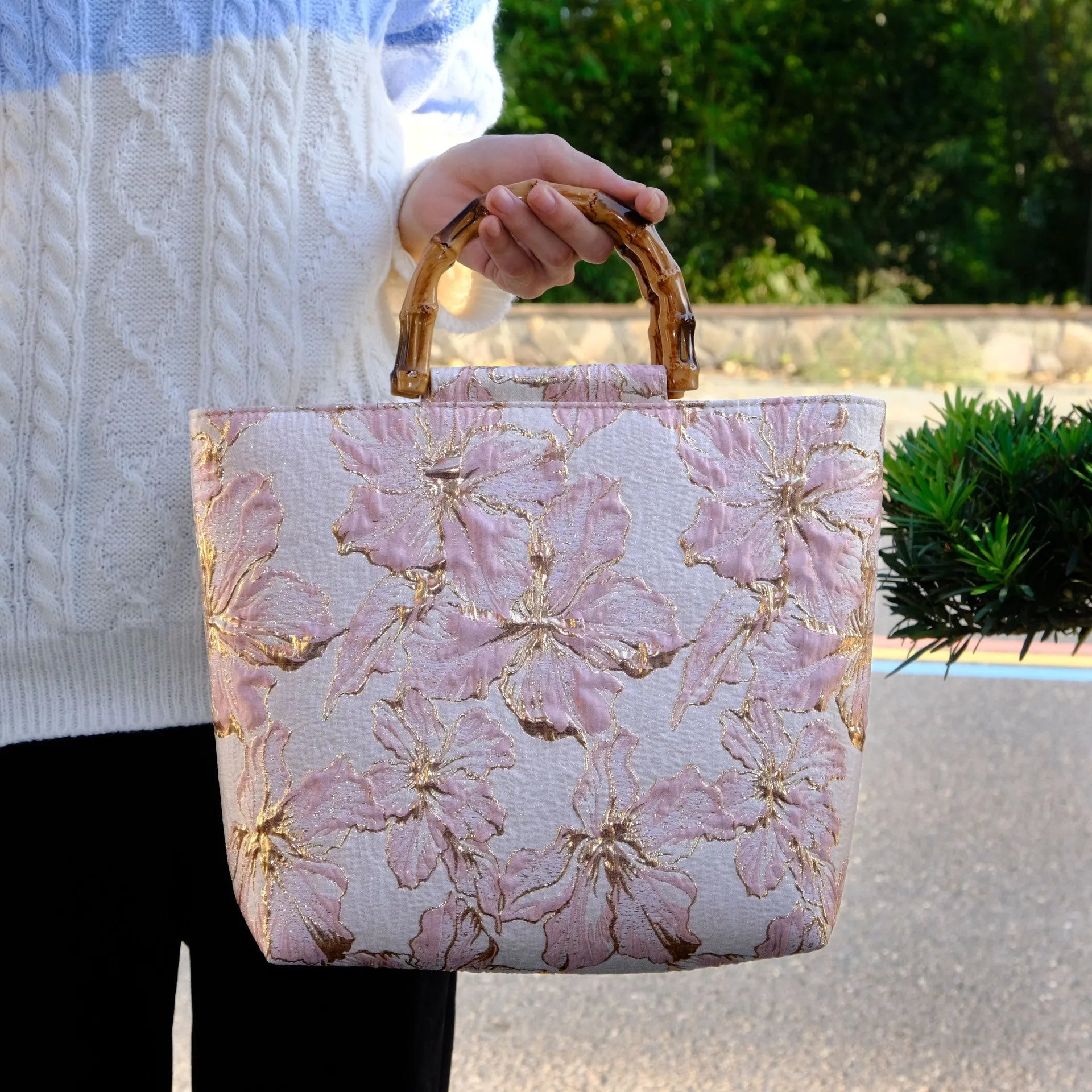 Light blue square canvas shoulder bag with bronzing flower detail and double strap connectors