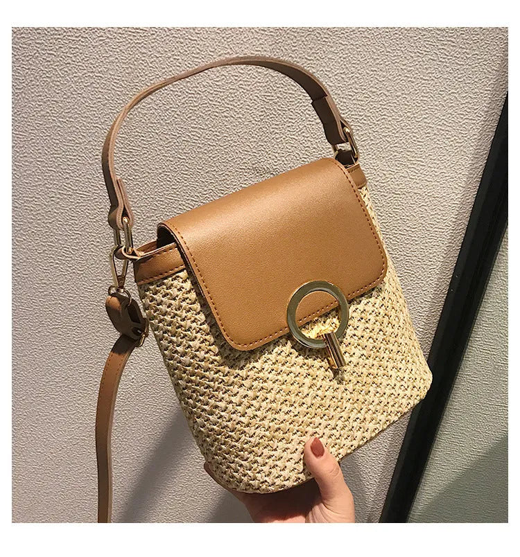 Women's straw woven bucket shoulder bag in black with cover flap, small size, polyester lining