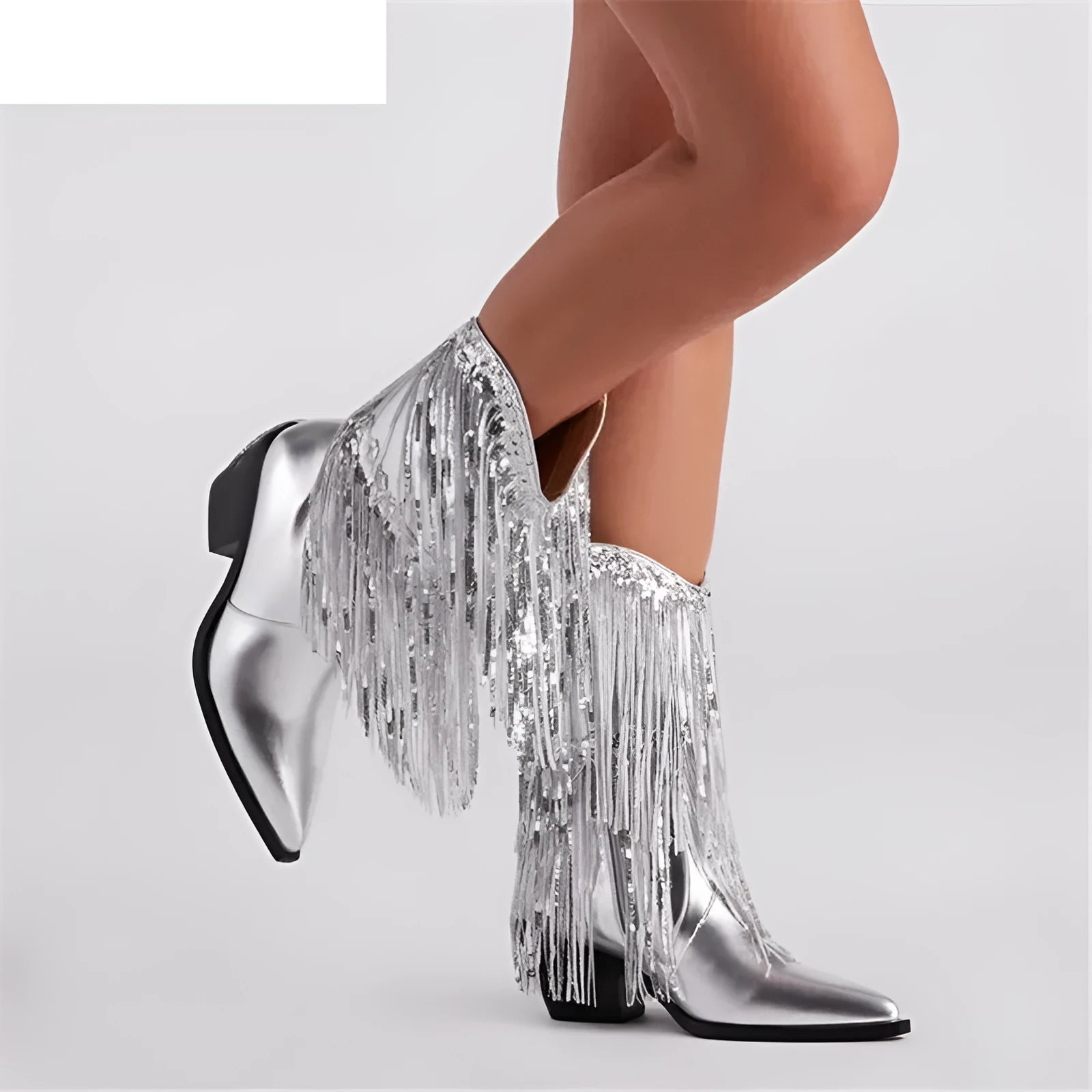 Women's black chunky heel tassel boots with pointed toe and high stiletto, shown on a model.