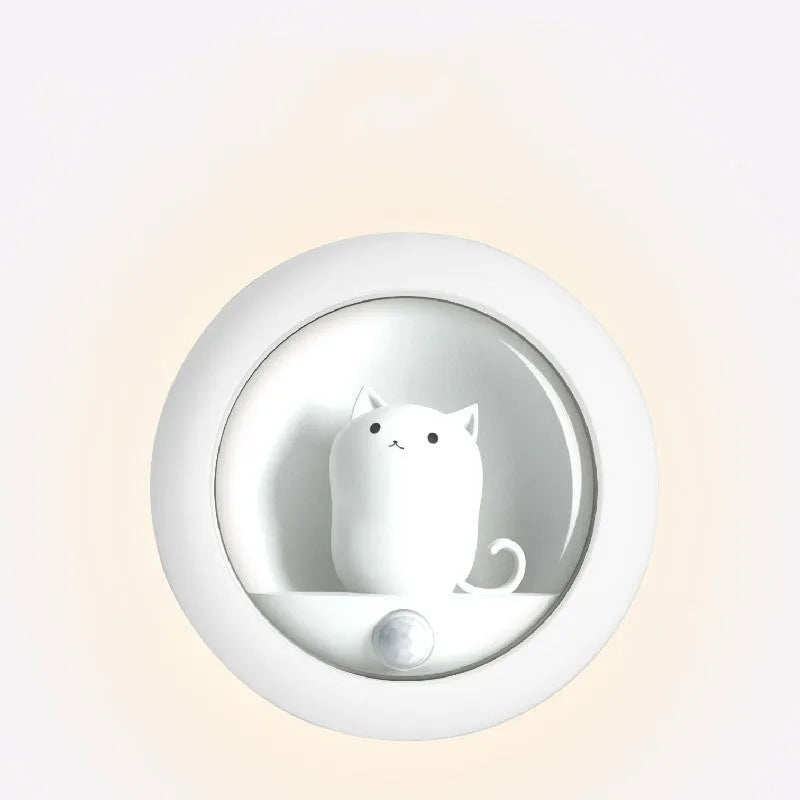 A white bedside sleep lamp for babies with orange, pink, and white light options and a projection feature on a nursery table.