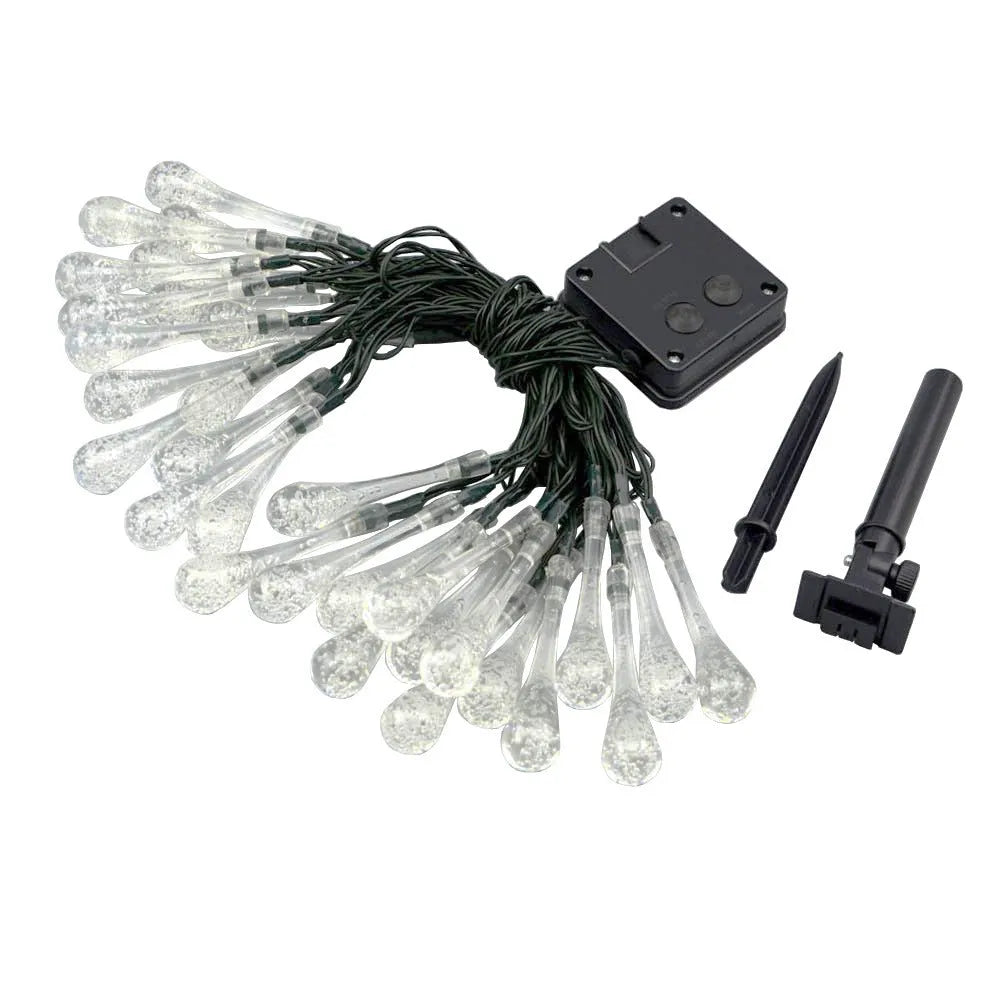 Solar-powered LED Water Drops string lights installed outdoors with 30 bulbs on a 6.5 metre waterproof cable