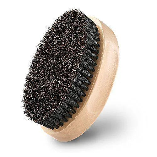 Natural boar beard brush for men in black finish with dense bristles on a table