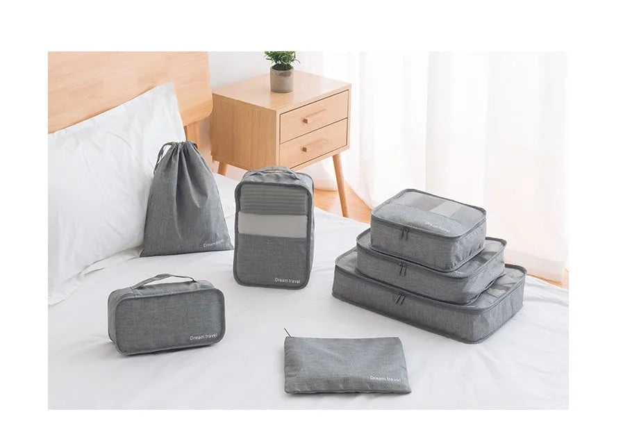 Seven-piece waterproof travel tote bag set in black and gray with six sorting bags and cation hardware
