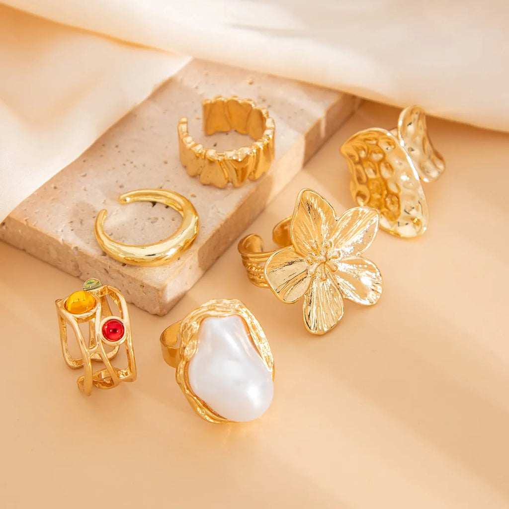 Women's open ring with liquid lava flower design, imitation pearl detail, available in gold or silver