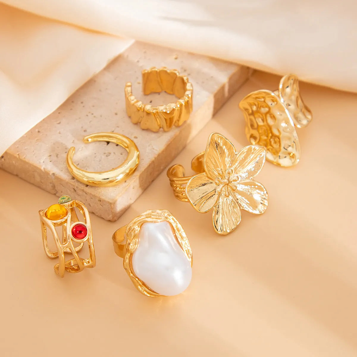 Women's open ring with liquid lava flower design, imitation pearl detail, available in gold or silver