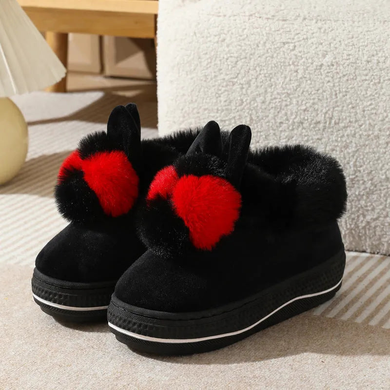 Pair of grey cotton plush high heel slippers with a thick TPR sole, shown on a wooden floor.
