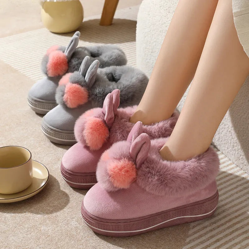 Pair of grey cotton plush high heel slippers with a thick TPR sole, shown on a wooden floor.