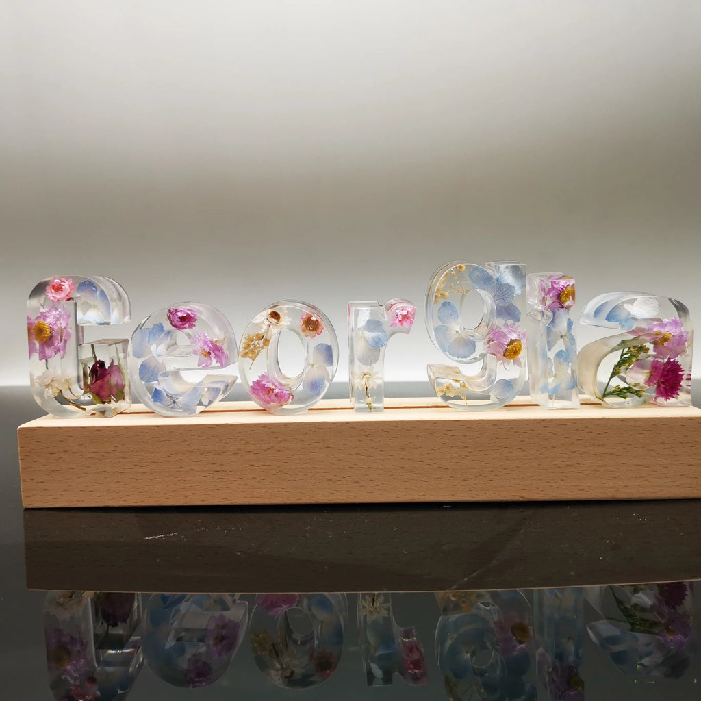 Crystal epoxy dried flower alphabet night light with white base showing letter shape