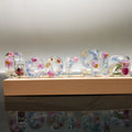 Crystal epoxy dried flower alphabet night light with white base showing letter shape