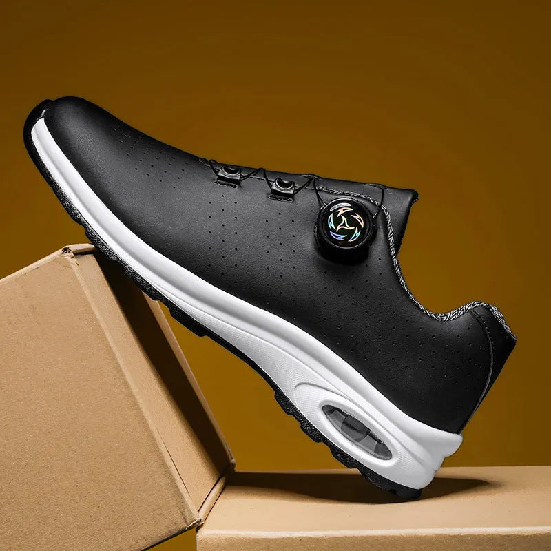 Black and white low top casual tennis shoes with mesh upper, cross shoulder straps, and composite sole.