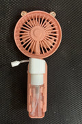 Compact apricot-coloured USB personal fan with a white plastic nozzle on a desk.