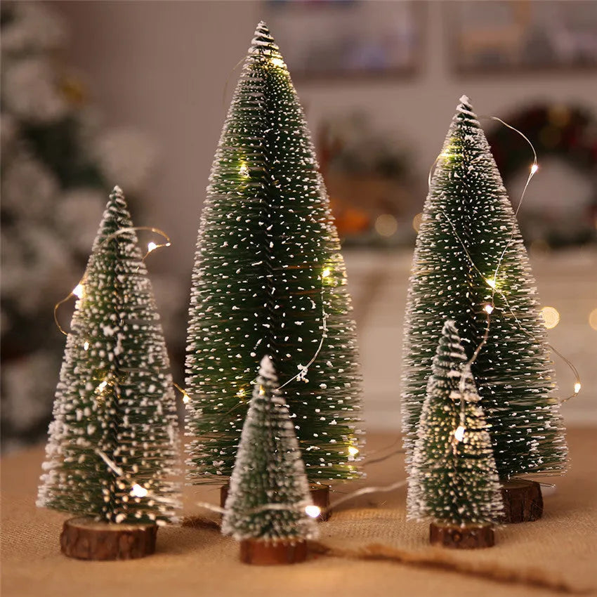 Set of artificial Christmas pine needle trees in green and white, heights 10cm to 30cm, on a tabletop