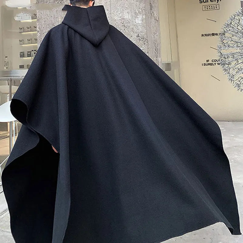 Men's solid black hooded cloak coat with loose streetwear punk fit, front view
