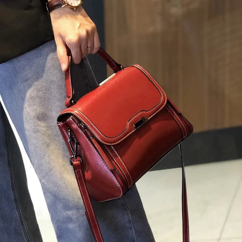 Women's brown genuine leather retro messenger bag with double strap and external pockets.