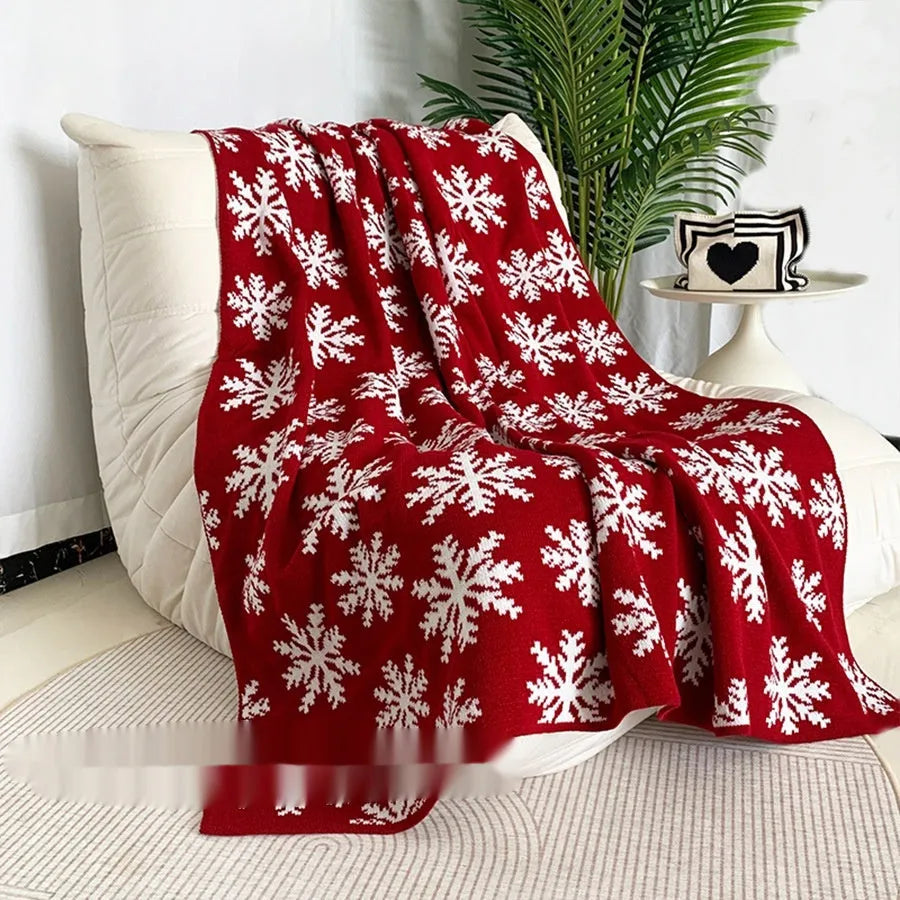 Personalised Christmas acrylic blanket with snowflake design draped over a sofa