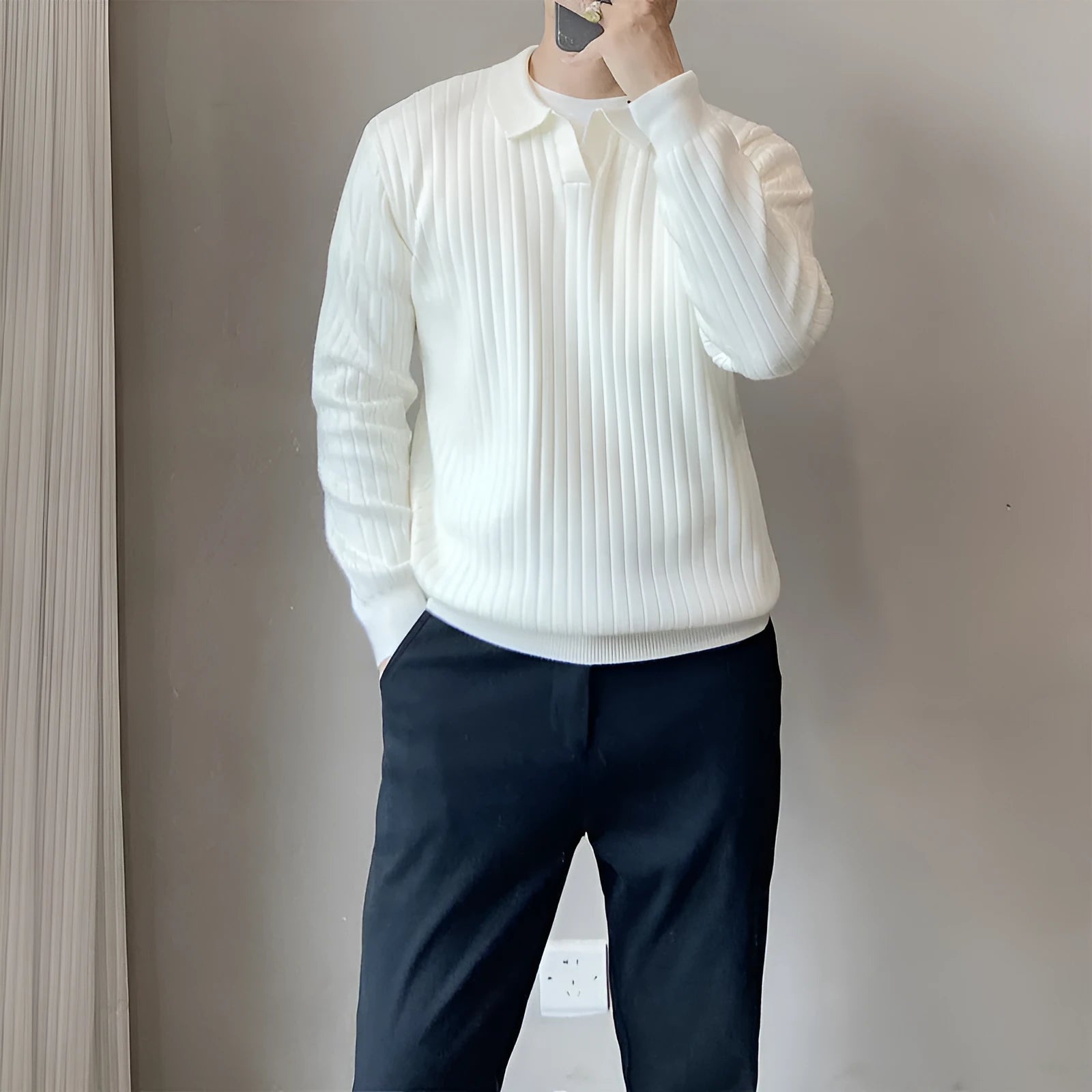 Men's loose grey knitted pullover sweater with long sleeves on a hanger.