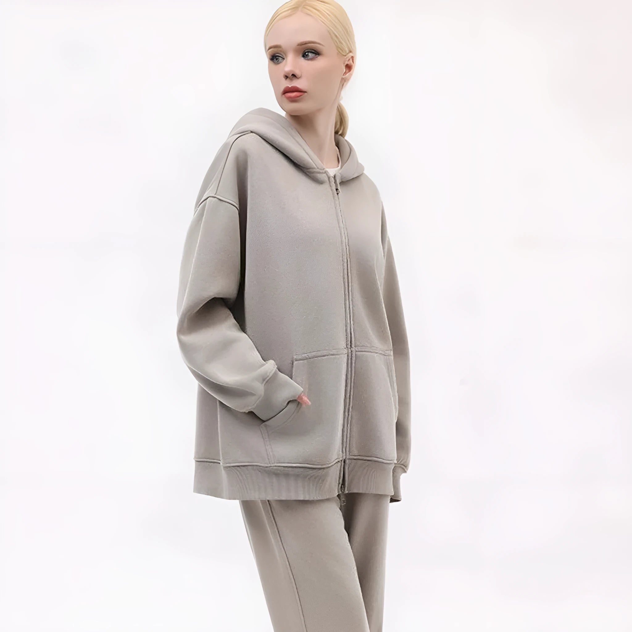 Woman wearing a distressed grey fleece-lined hooded cardigan with patch pockets.