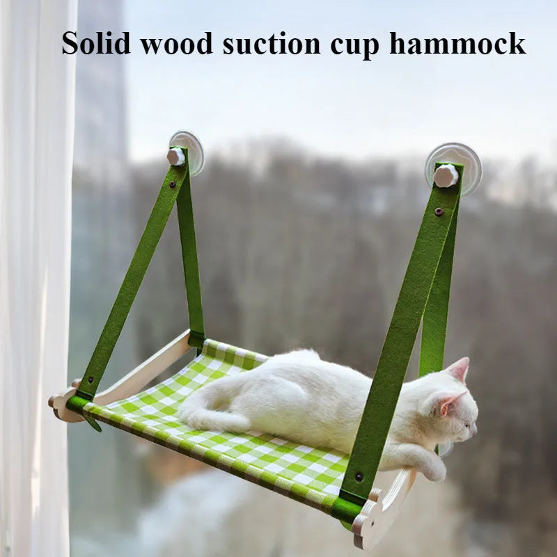 Pink foldable wooden cat window bed with suction cups attached to a glass window