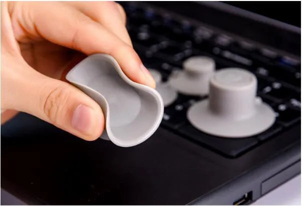 Grey plastic laptop cooling pad stand with four pieces for temperature reduction and ergonomic typing