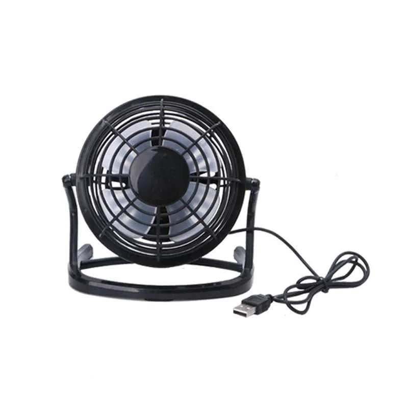 Small black USB desk fan with adjustable head and key switch on a wooden desk.