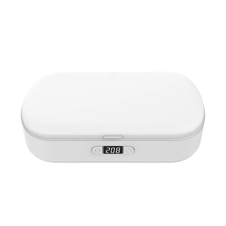 White ABS plastic wireless UV steriliser box with phone inside, showing charging indicator.