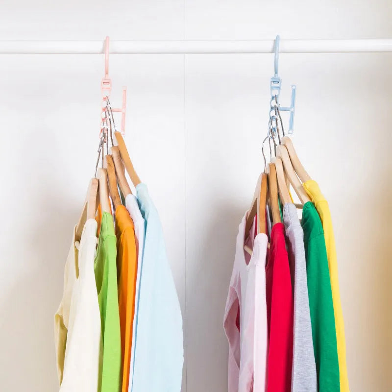 Blue revolving plastic wardrobe hanger with five arms and a top handle for rotation.
