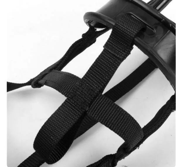 Soft silicone dog muzzle in black with cotton webbing strap on a table, anti-bite and anti-eating design