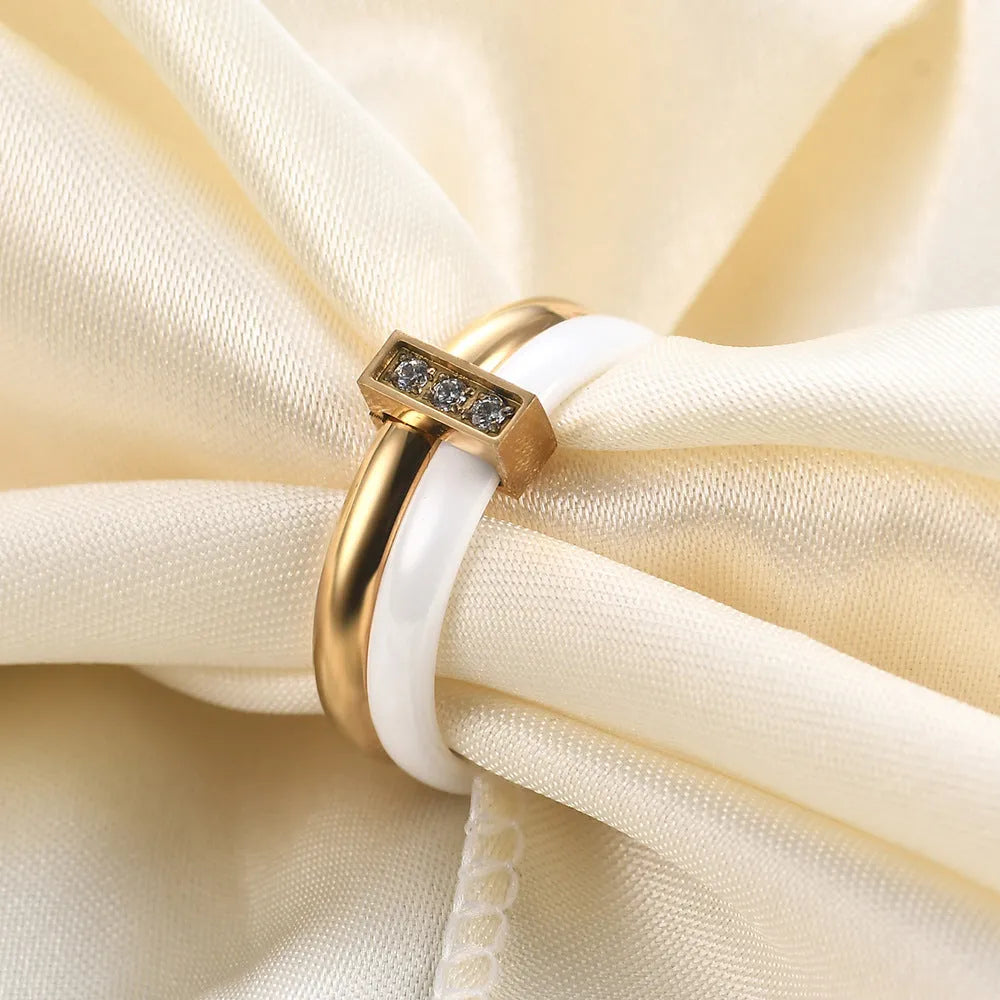 Ceramic geometric ring with glossy stitching and inlaid zirconium on 6MM band, shown in steel black and gold white finishes