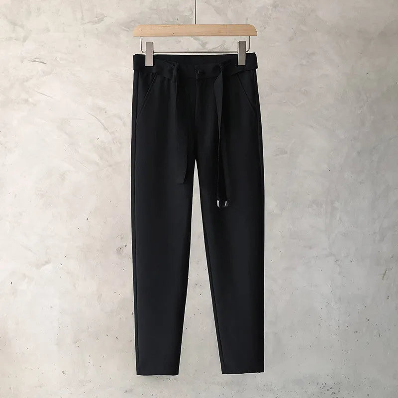 Boy wearing slim straight grey wool blend business casual trousers with a tapered fit