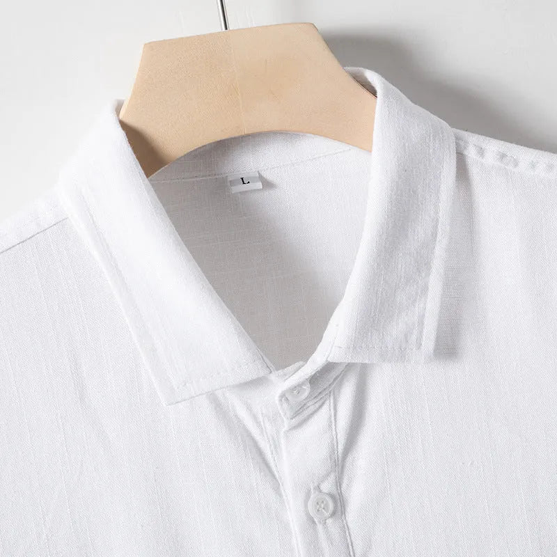 Man wearing a solid colour linen T-shirt with loose lapels and short sleeves.